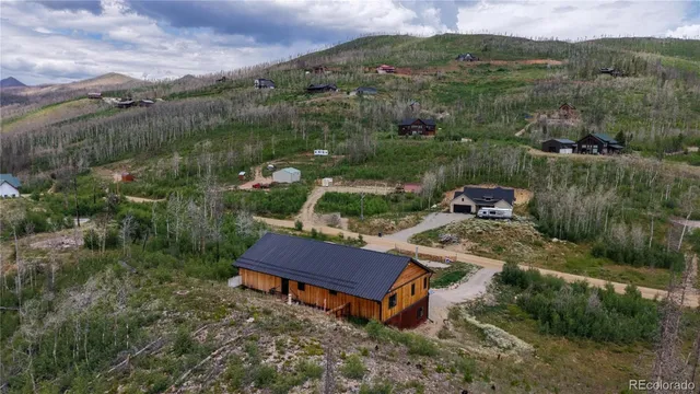 an aerial view of a house with river lake view and mountain view
