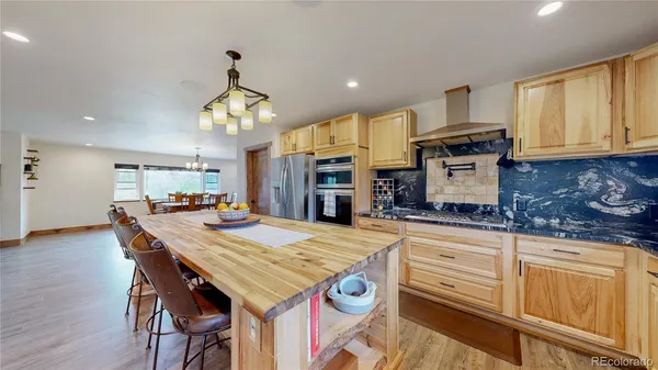 a kitchen with granite countertop a sink appliances and cabinets