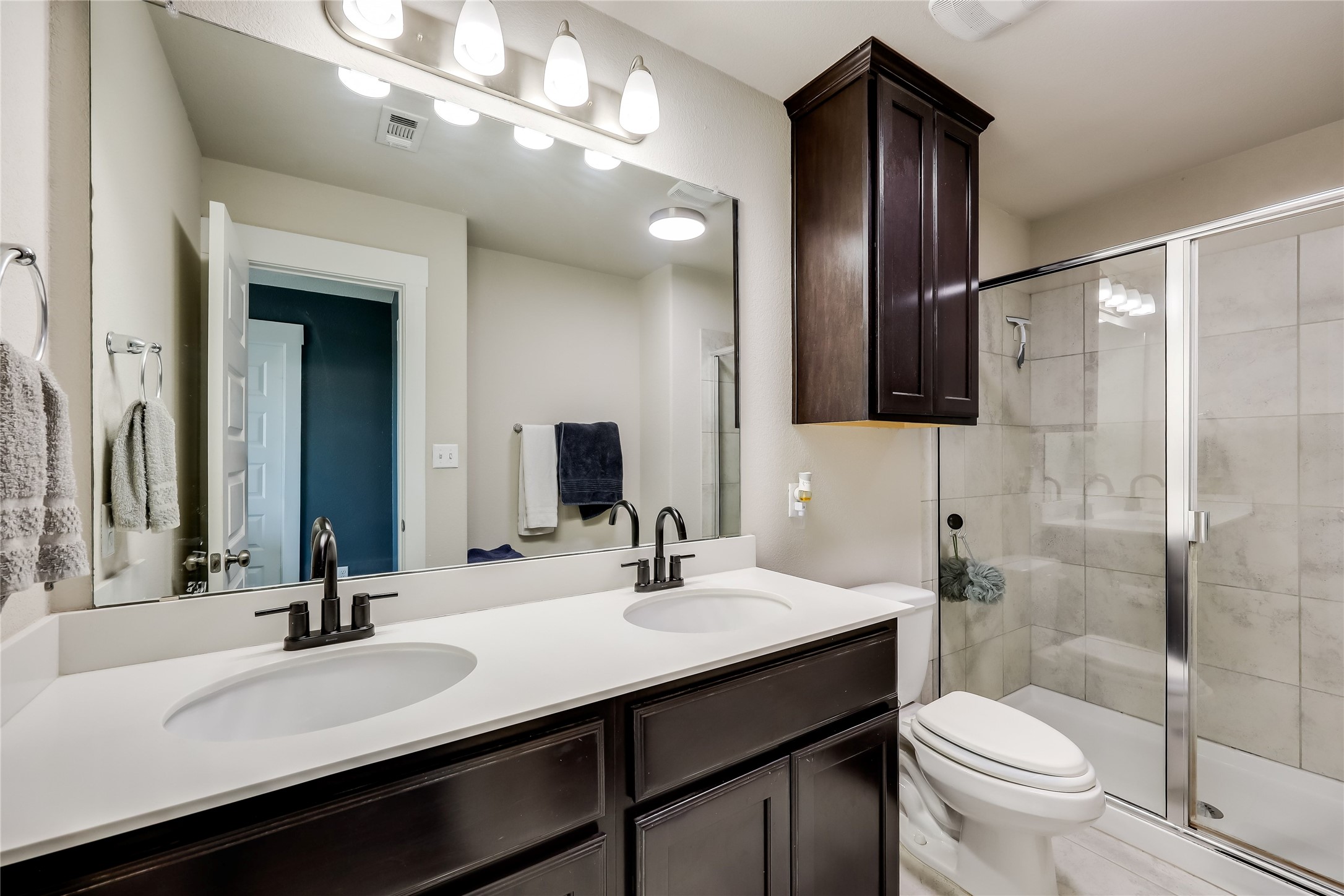 249 Trellis Boulevard Leander, TX 78641 - Photo 12 of 18 a bathroom with a sink a toilet and shower