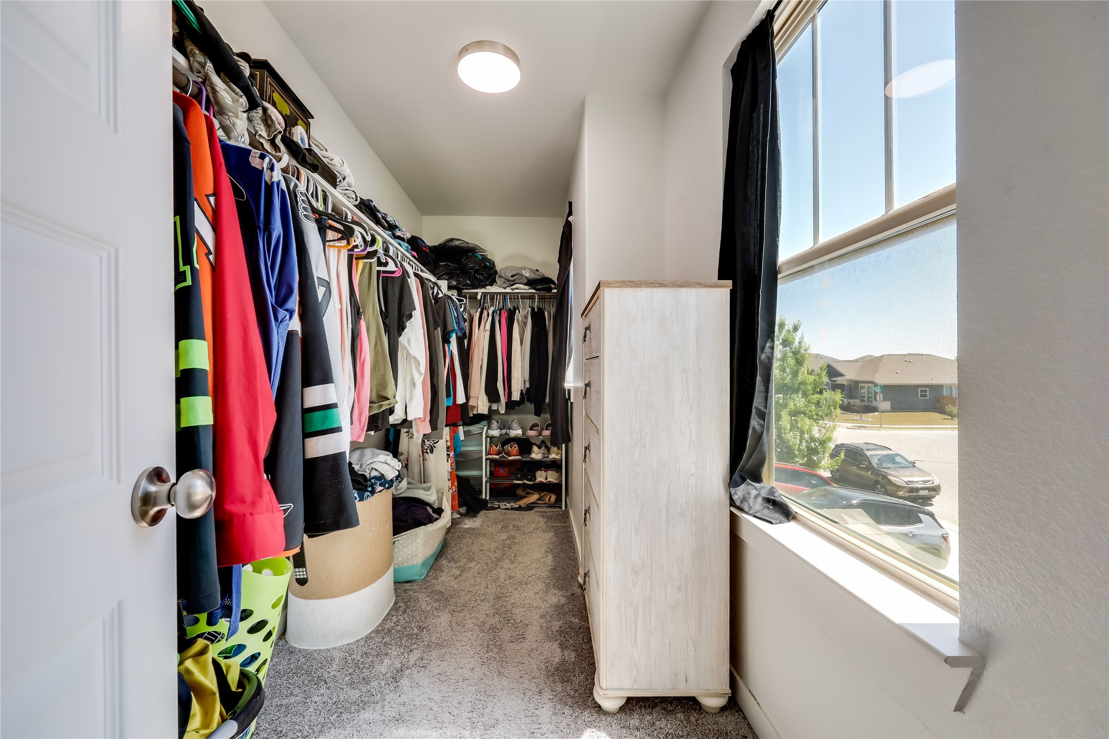 249 Trellis Boulevard Leander, TX 78641 - Photo 13 of 18 a view of walk in closet with clothes and shoes