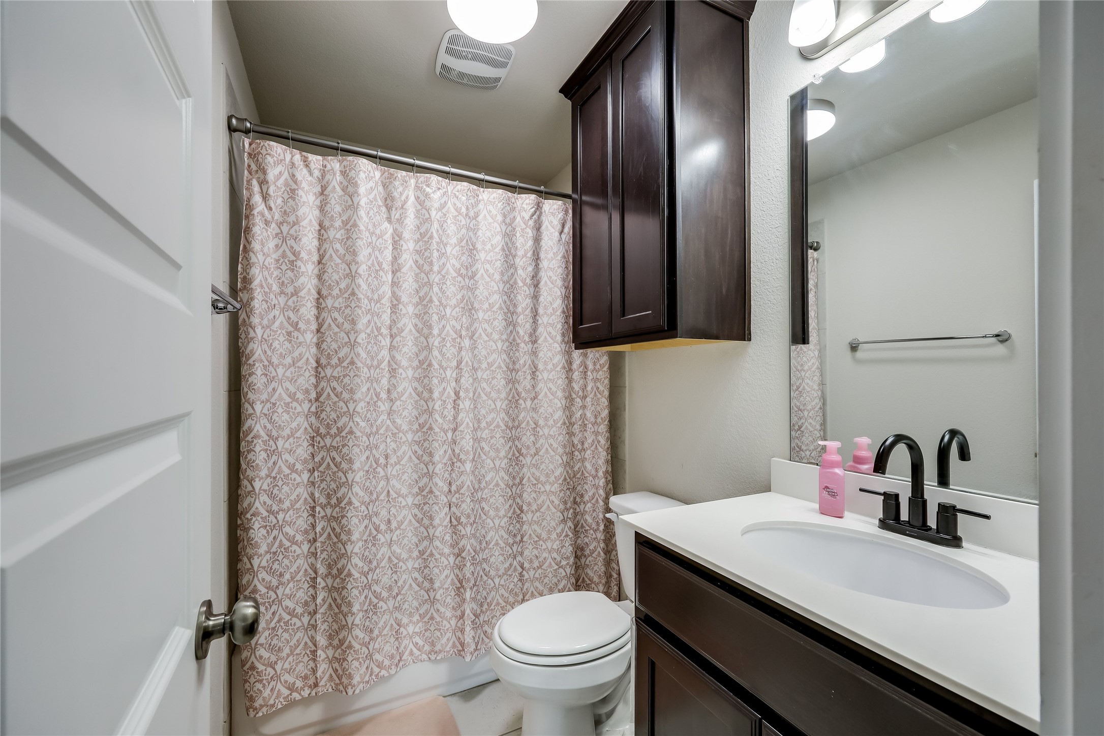 249 Trellis Boulevard Leander, TX 78641 - Photo 15 of 18 a bathroom with a sink a toilet and shower curtain