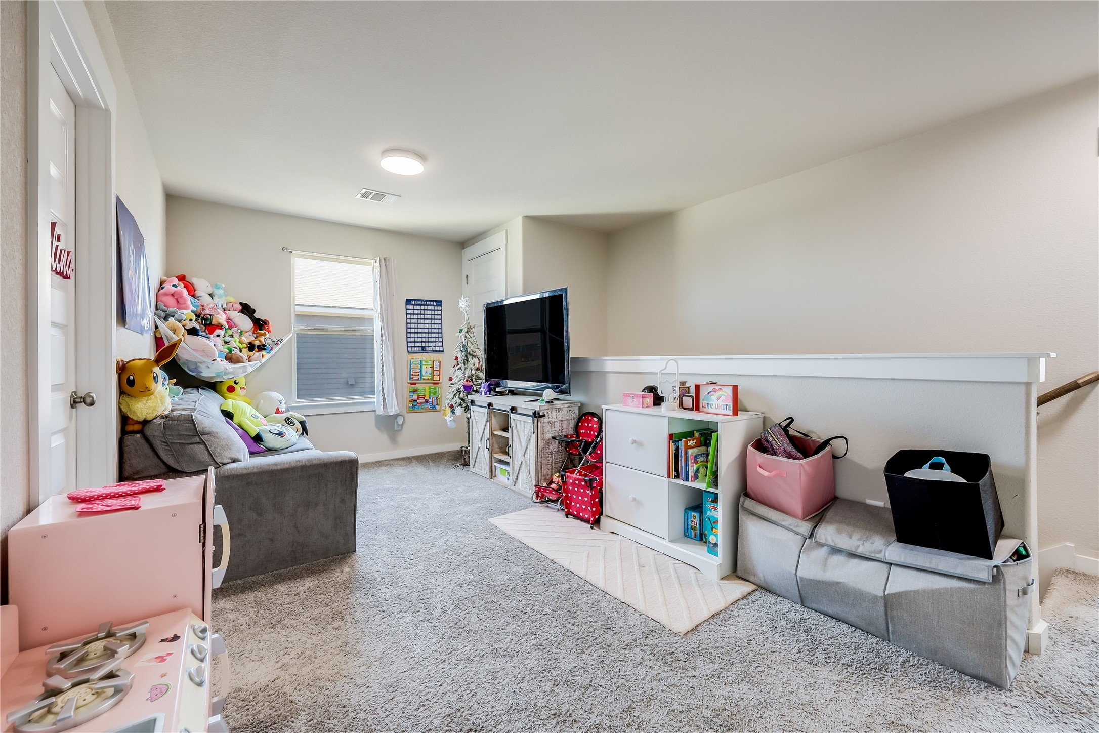 249 Trellis Boulevard Leander, TX 78641 - Photo 10 of 18 a living room with furniture and a flat screen tv