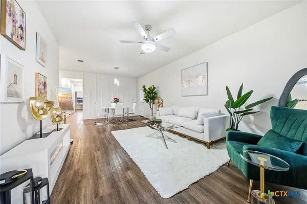 a living room with furniture and a chandelier