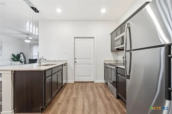 a kitchen with cabinets and stainless steel appliances