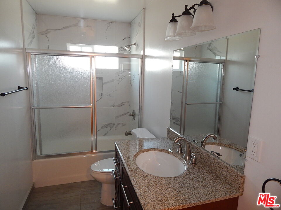 2018 Hillcrest Drive Los Angeles, CA 90016 - Photo 11 of 19 a bathroom with a granite countertop sink toilet and shower
