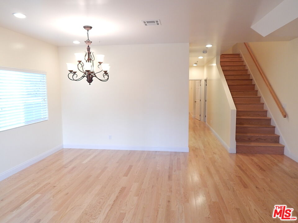 2018 Hillcrest Drive Los Angeles, CA 90016 - Photo 3 of 19 a view of a room with wooden floor staircase and kitchen view