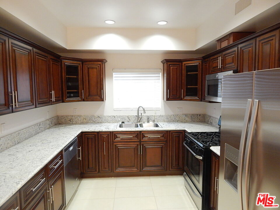 2018 Hillcrest Drive Los Angeles, CA 90016 - Photo 4 of 19 a kitchen with a sink stove and cabinets