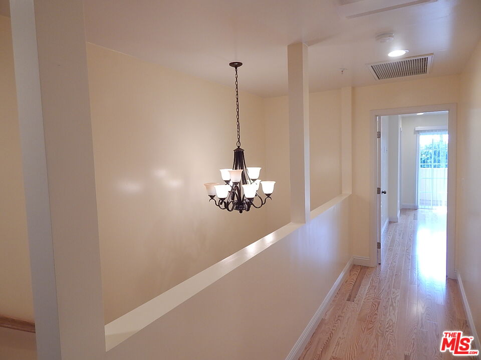 2018 Hillcrest Drive Los Angeles, CA 90016 - Photo 9 of 19 a view of a hallway with wooden floor