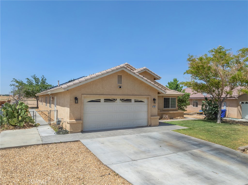 14952 Rivers Edge Road Helendale, CA 92342 - Photo 9 of 33 a view of a white house next to a yard with potted plants
