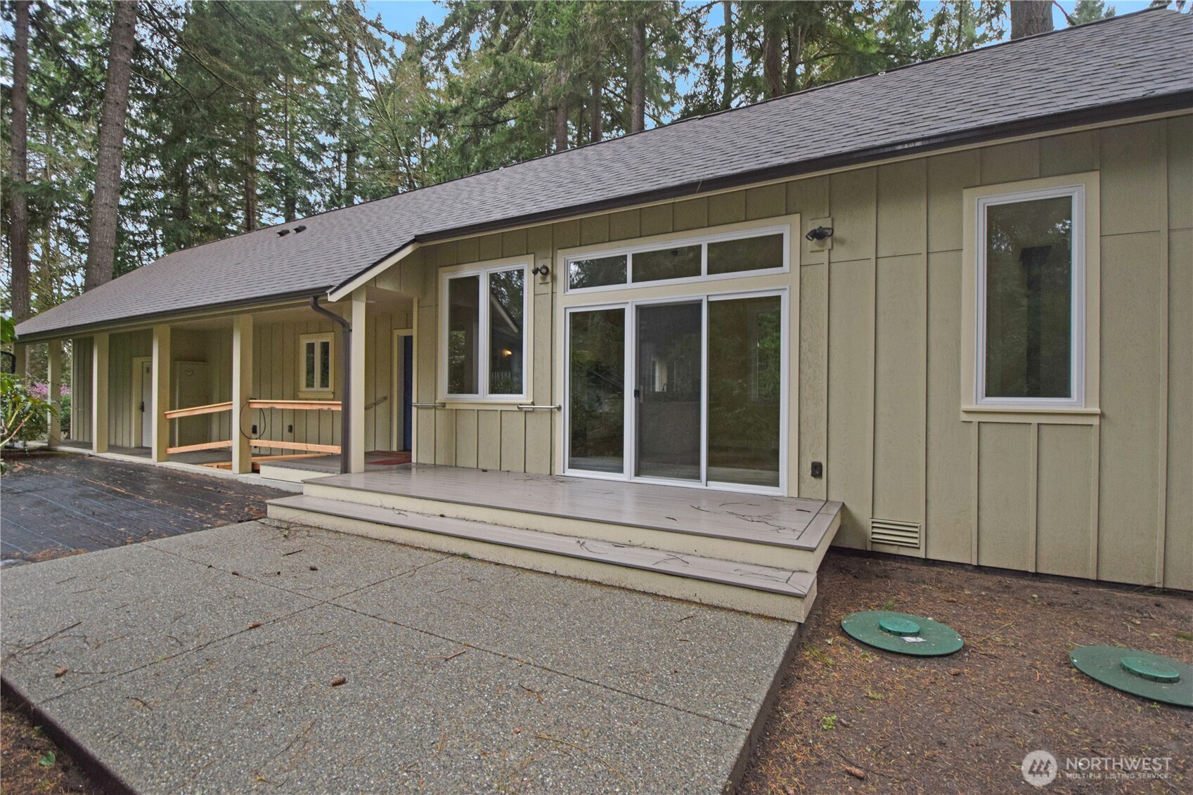 15915 Nesika Bay Road Northeast Poulsbo, WA 98370 - Photo 1 of 40 a front view of a house with a large window and potted plant
