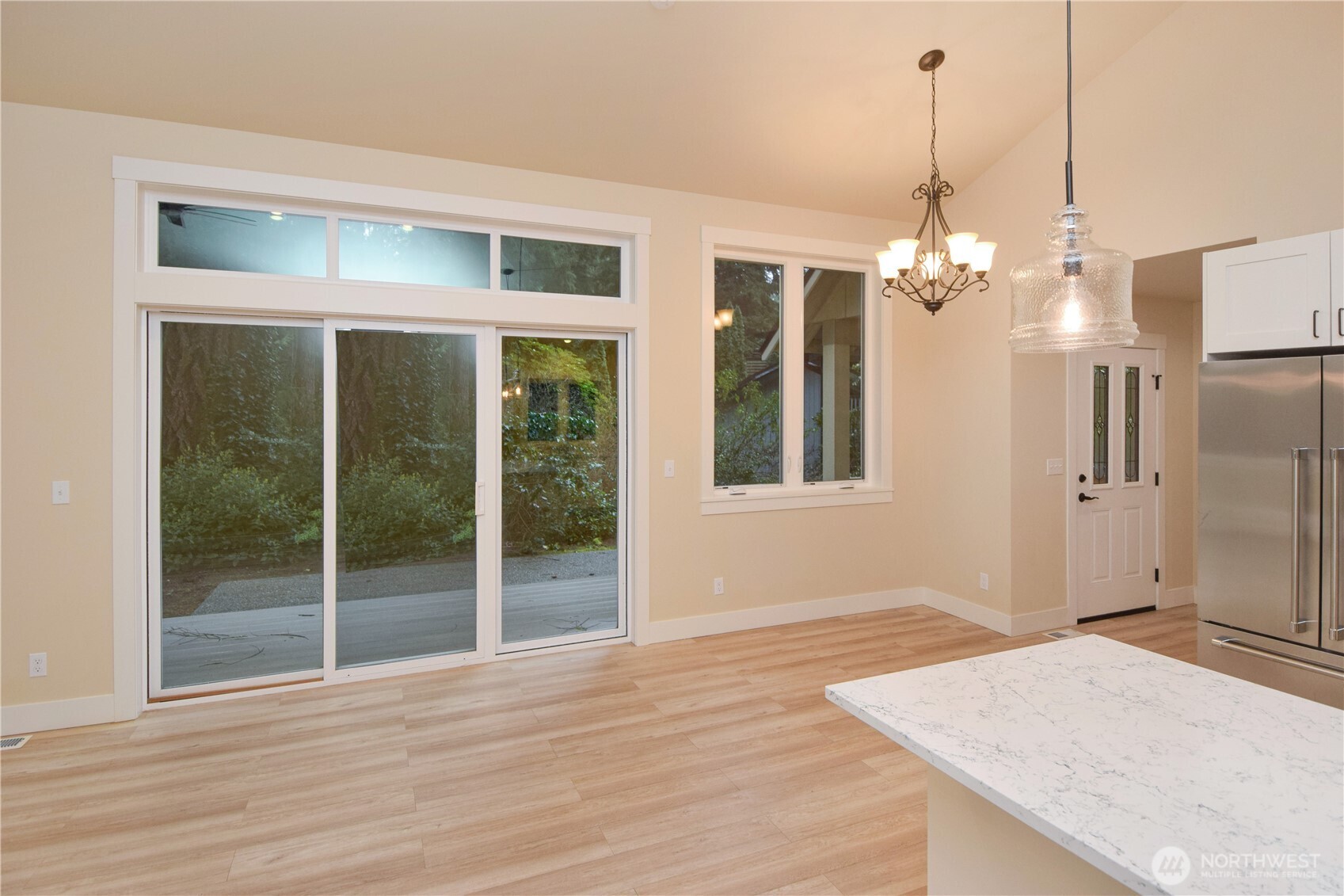 15915 Nesika Bay Road Northeast Poulsbo, WA 98370 - Photo 12 of 40 a view of a hallway with wooden floor and chandelier