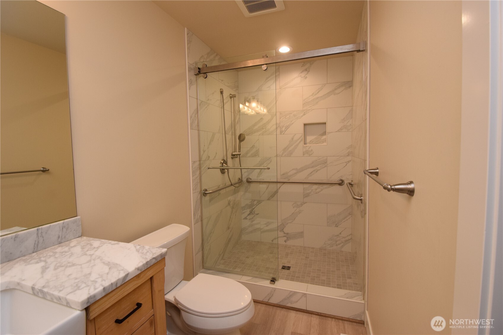 15915 Nesika Bay Road Northeast Poulsbo, WA 98370 - Photo 17 of 40 a bathroom with a granite countertop sink toilet and shower