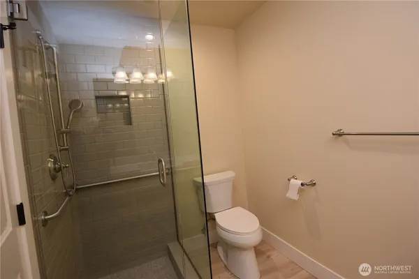 a bathroom with a shower a toilet and sink