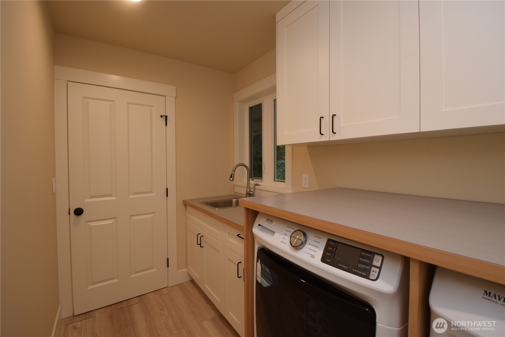 15915 Nesika Bay Road Northeast Poulsbo, WA 98370 - Photo 24 of 40 a kitchen with a sink and cabinets