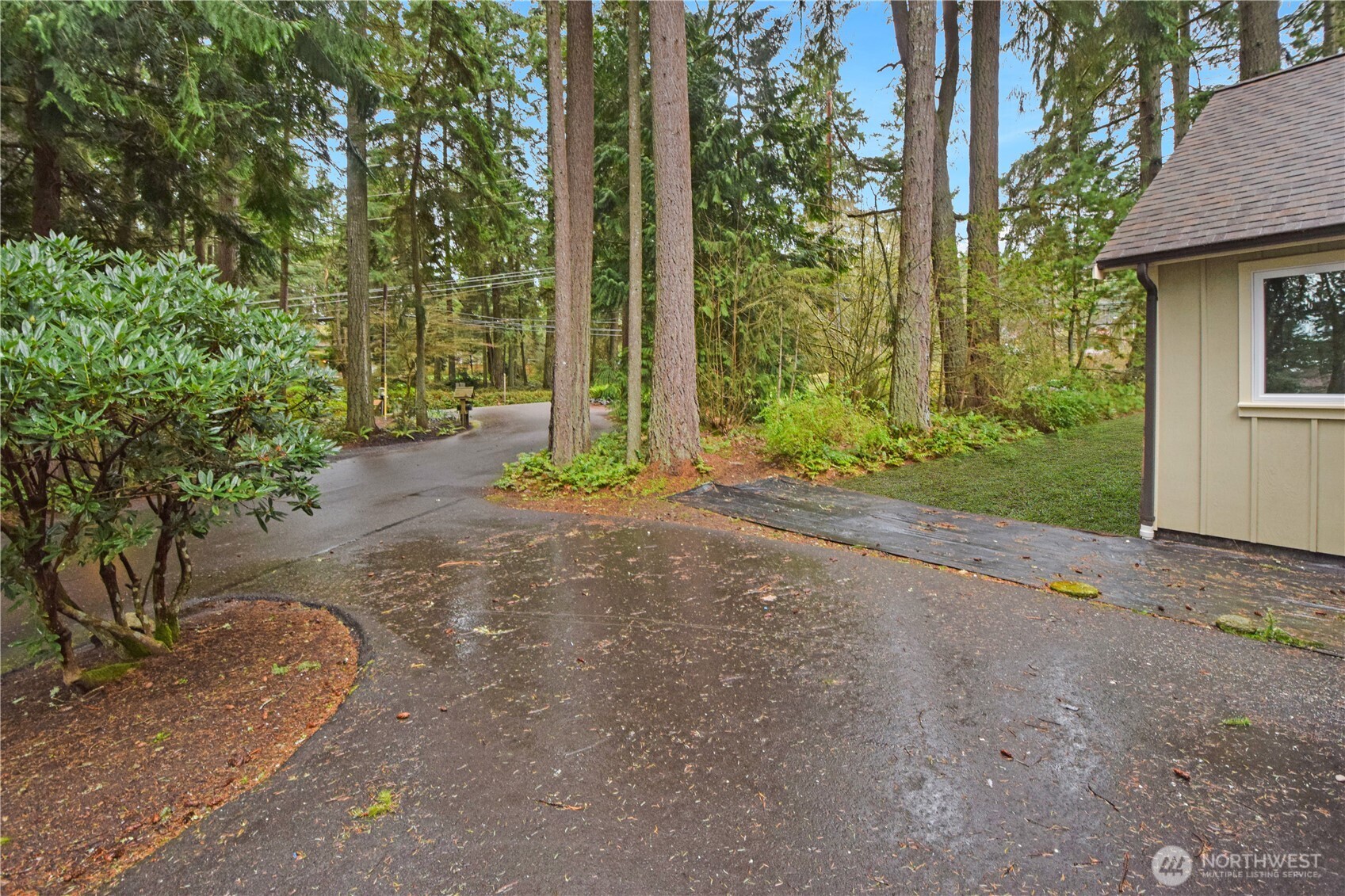15915 Nesika Bay Road Northeast Poulsbo, WA 98370 - Photo 29 of 40 a view of a house with backyard and garden