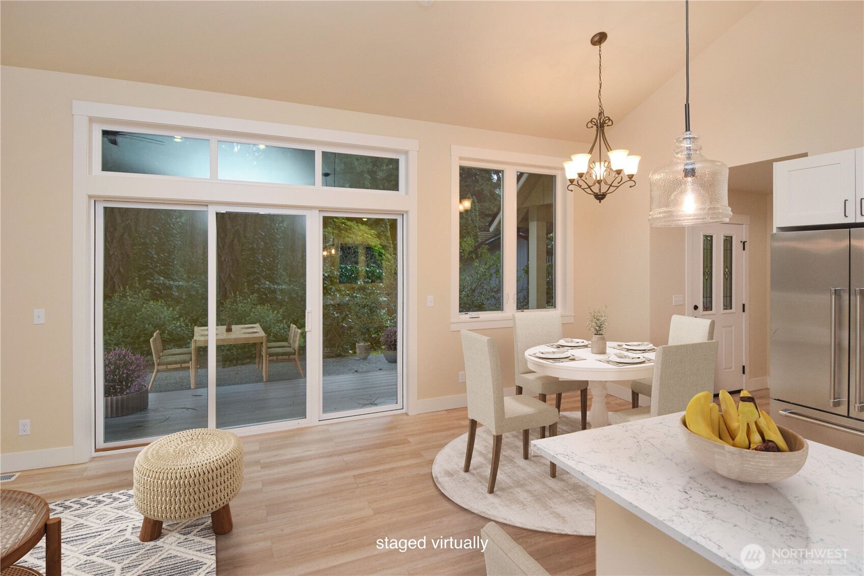 15915 Nesika Bay Road Northeast Poulsbo, WA 98370 - Photo 5 of 40 a view of a dining room with furniture wooden floor and chandelier