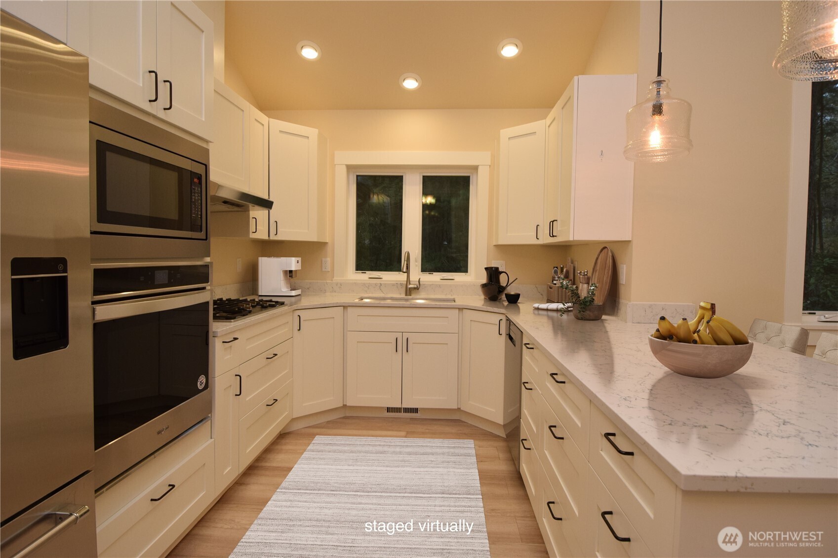 15915 Nesika Bay Road Northeast Poulsbo, WA 98370 - Photo 6 of 40 a kitchen with sink a microwave and cabinets