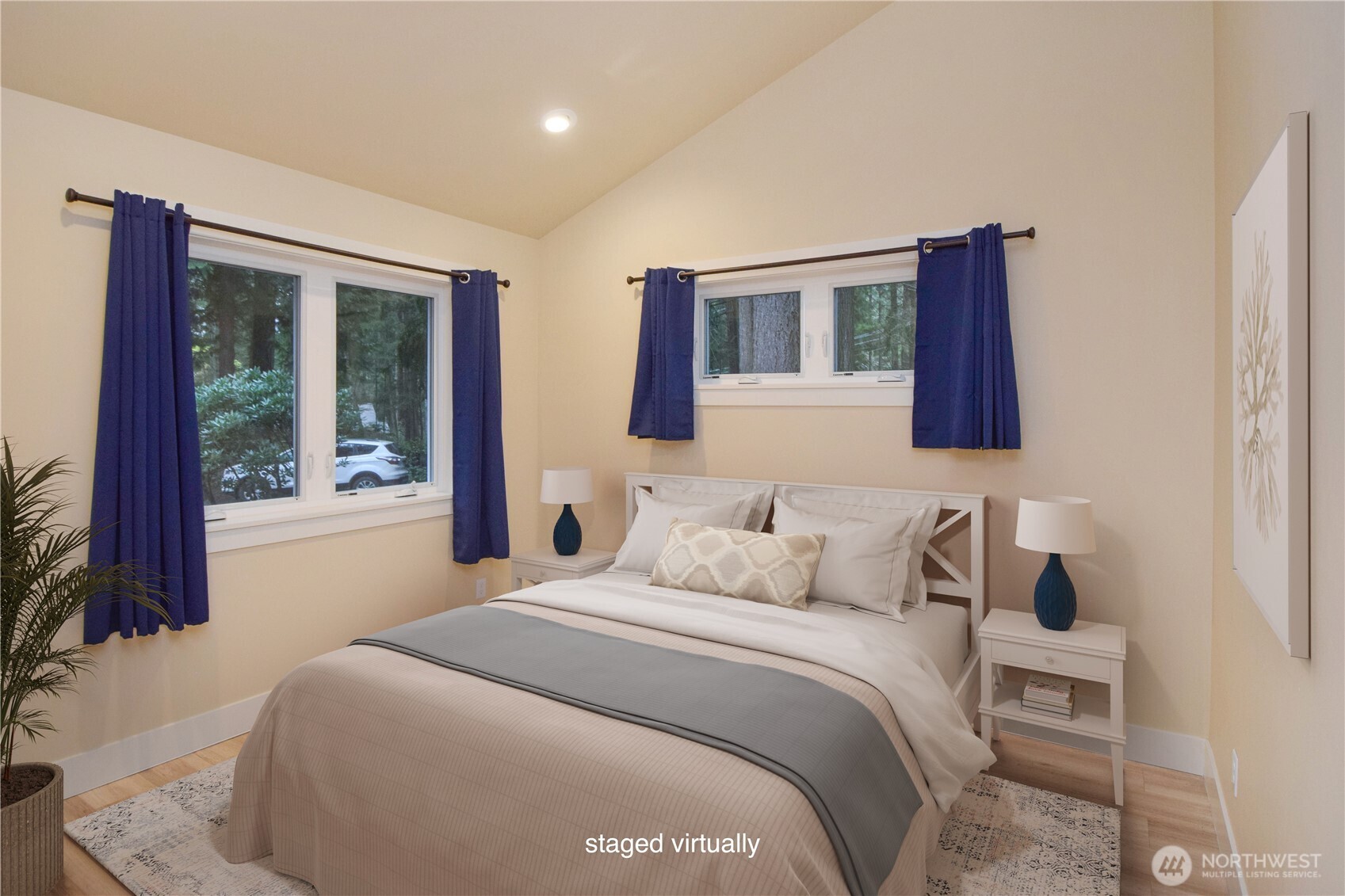 15915 Nesika Bay Road Northeast Poulsbo, WA 98370 - Photo 7 of 40 a bedroom with a large bed and a large window
