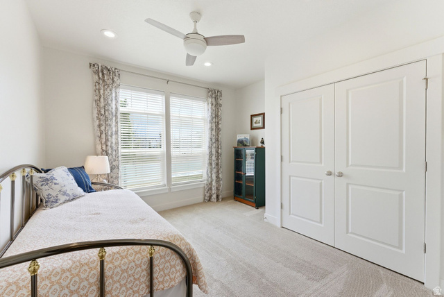 108 West Monte Rosa Lane Midway, UT 84049 - Photo 25 of 48 Bright room featuring a window with blinds and drapes, recessed lighting, a ceiling fan, plush carpet flooring, and double bifold closet doors