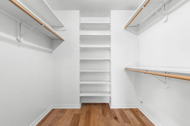 a view of walk in closet with empty racks