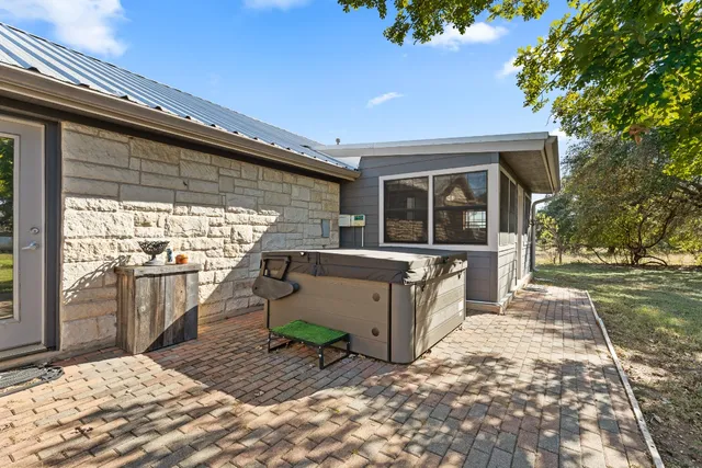 a view of a patio with a table and chairs