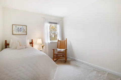 a bedroom with a bed and a chair