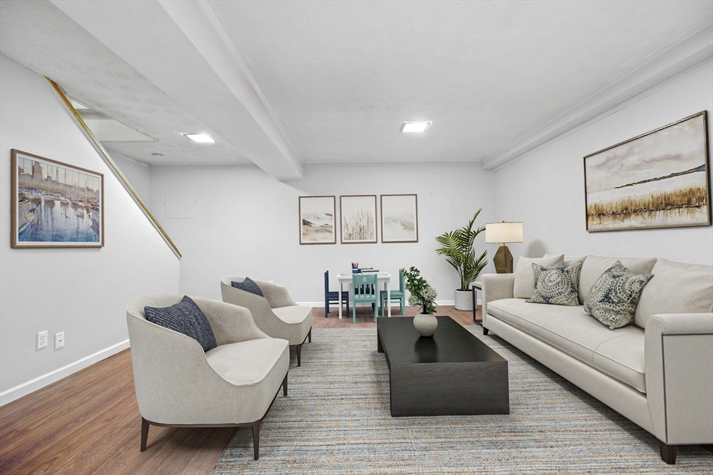 1 Charles Street, Unit N Reading, MA 01867 - Photo 13 of 17 a living room with furniture and a wooden floor