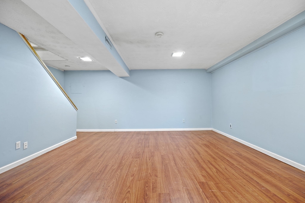 1 Charles Street, Unit N Reading, MA 01867 - Photo 14 of 17 a view of an empty room with wooden floor