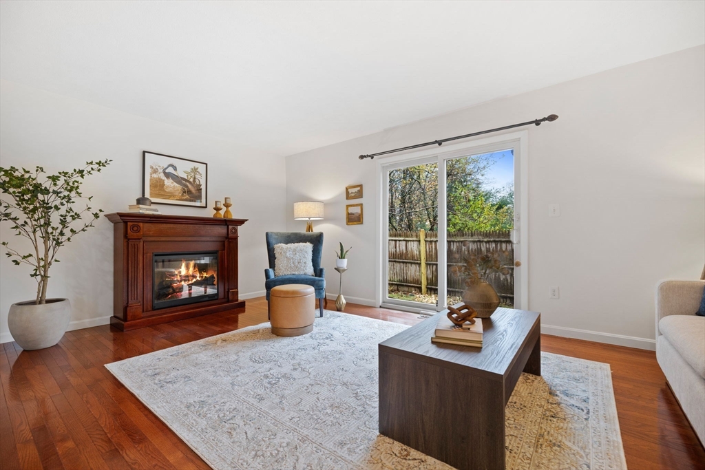 1 Charles Street, Unit N Reading, MA 01867 - Photo 3 of 17 a living room with furniture and a fireplace