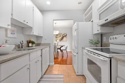a kitchen with a refrigerator and a sink