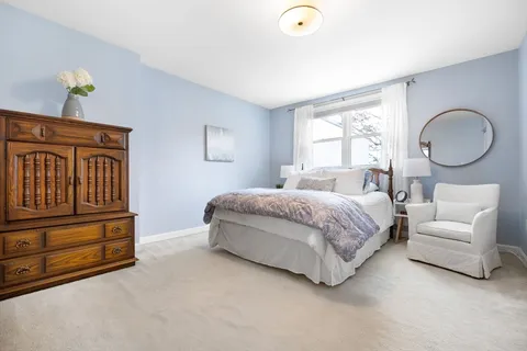 a bedroom with a bed couch and window