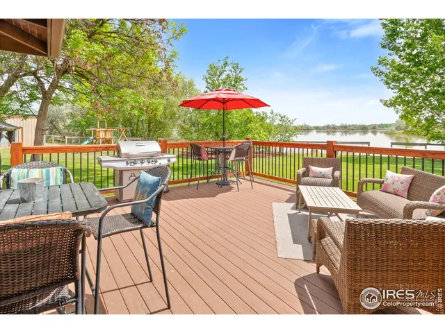 a view of a balcony with furniture and wooden floor