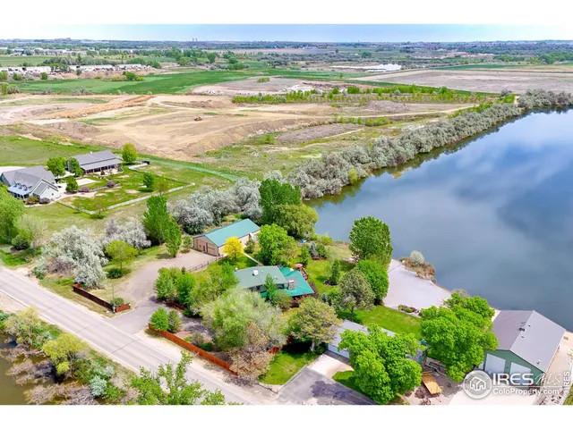 a living room with fireplace furniture and a large window