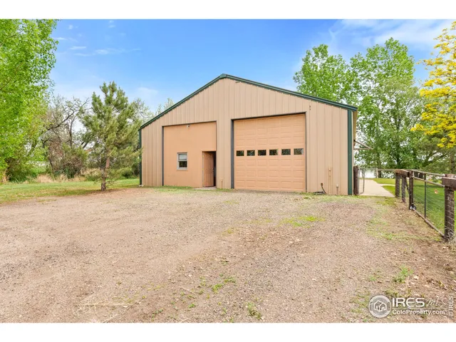 a backyard of a house with fire pit and outdoor seating