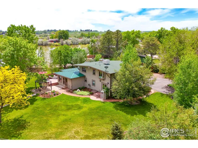 a living room with furniture a dining table and chairs with wooden floor