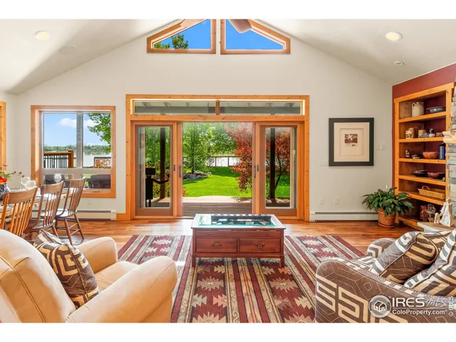 a living room filled with furniture and a large window
