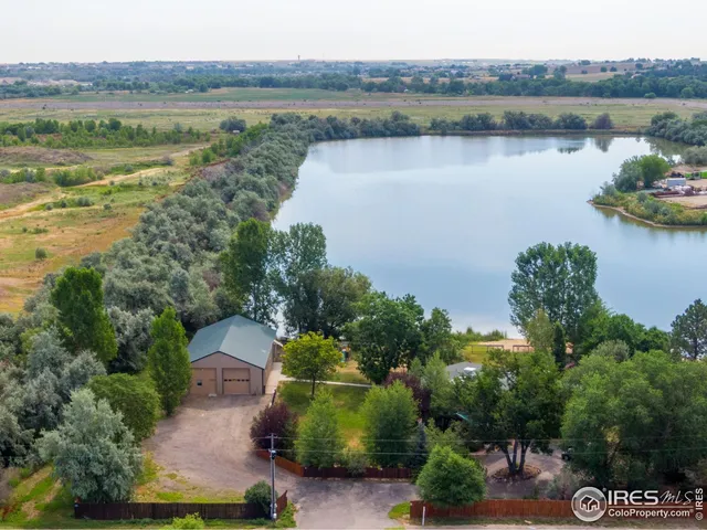 an aerial view of a house with a lake view