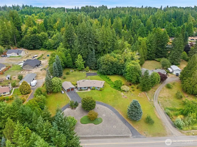 an aerial view of a house with yard swimming pool and outdoor seating
