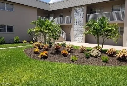 a garden with a bench and potted plants