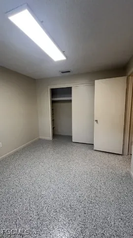 a bathroom with a toilet and a mirror