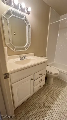 a bathroom with a sink a toilet and a shower