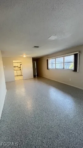 an empty room with a empty space and windows