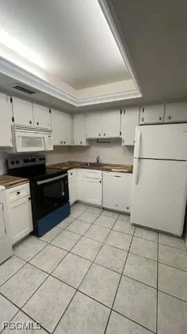 a kitchen with a stove a sink and a refrigerator