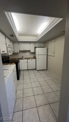 a kitchen with a sink a stove and cabinets