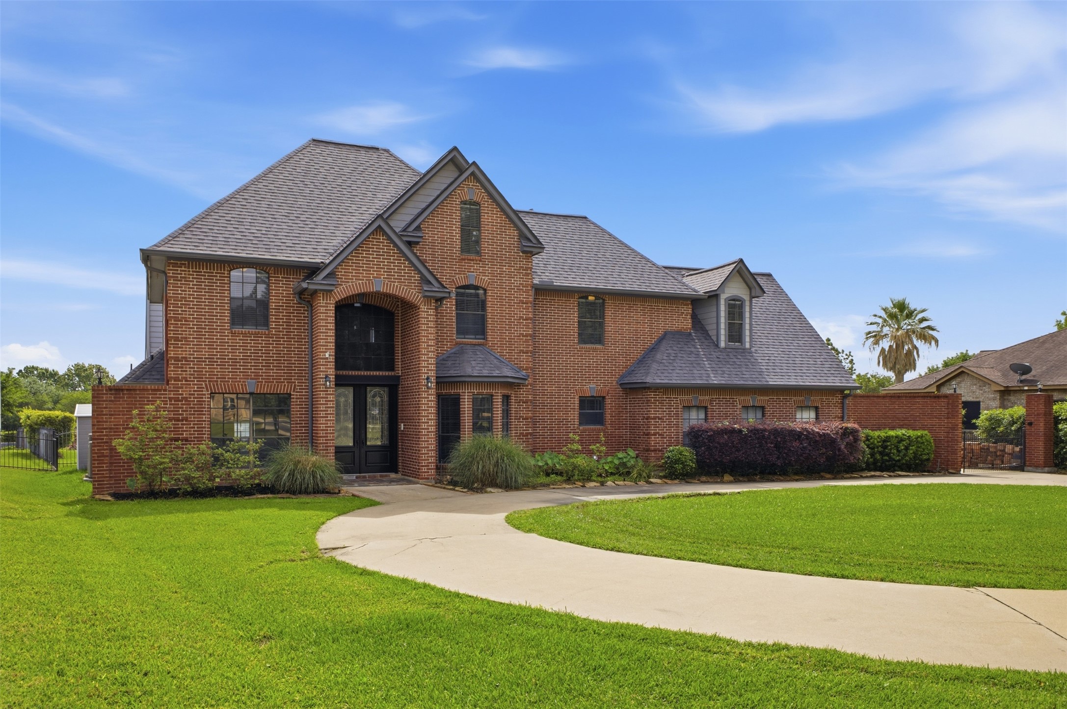 The property features an extensive brick facade with a prominent gabled roofline and dormer windows