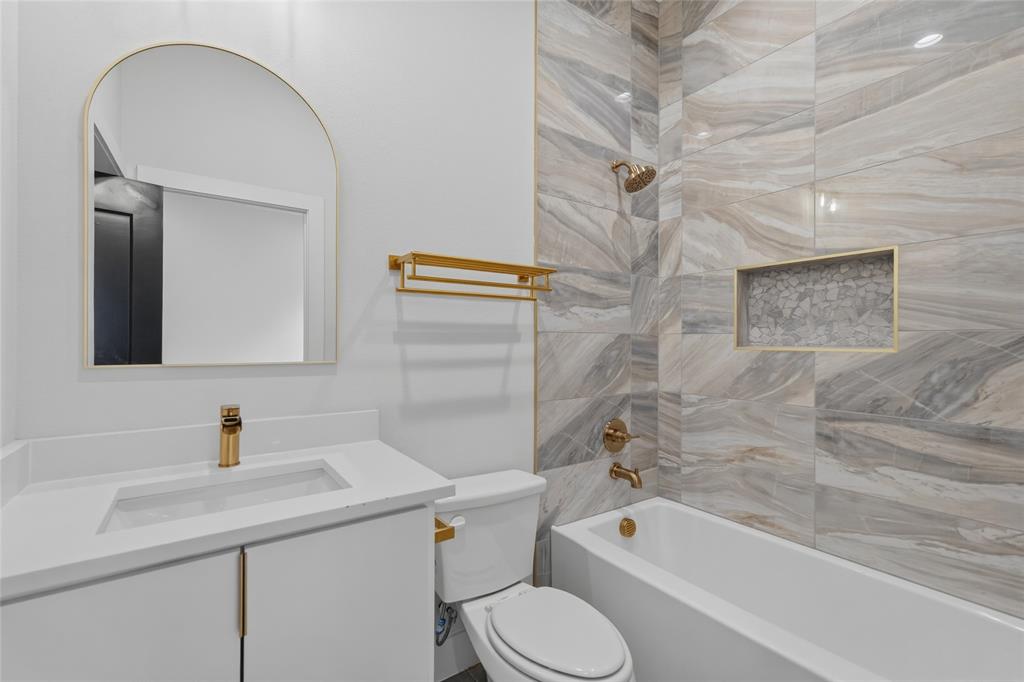 3914 Harlingen Street Dallas, TX 75212 - Photo 25 of 28 a bathroom with a sink a toilet and shower