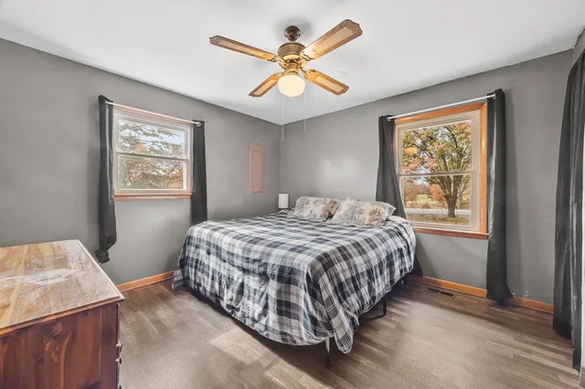 a view of a workspace with furniture and wooden floor