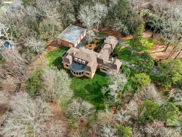 an aerial view of a house with garden space and street view