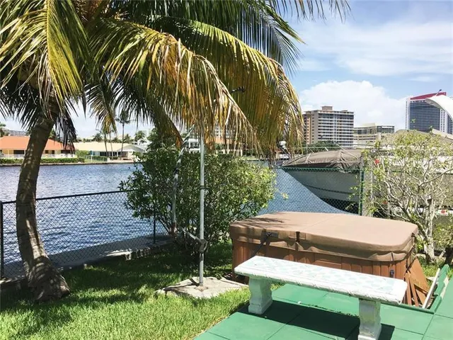 a view of swimming pool with palm trees