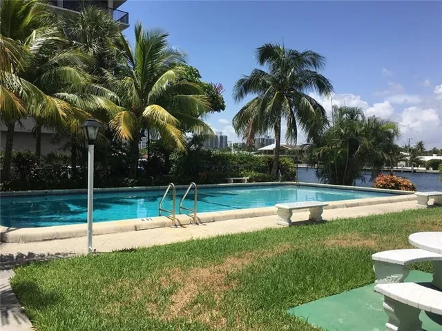 a view of a house with fountain and plants